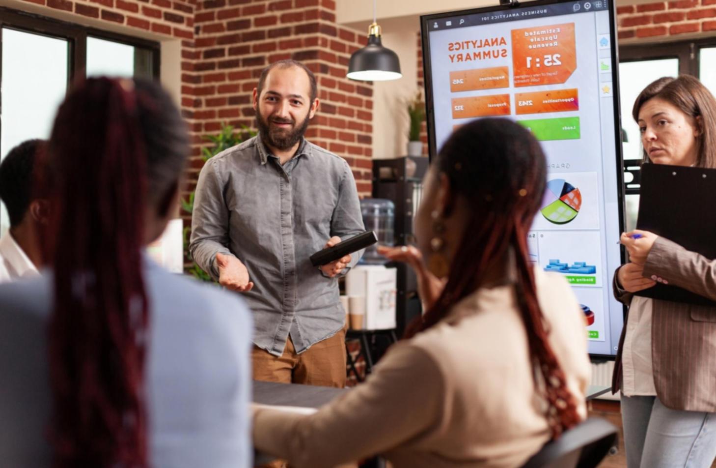 Business professional reviewing financial reports and metrics on computer screen